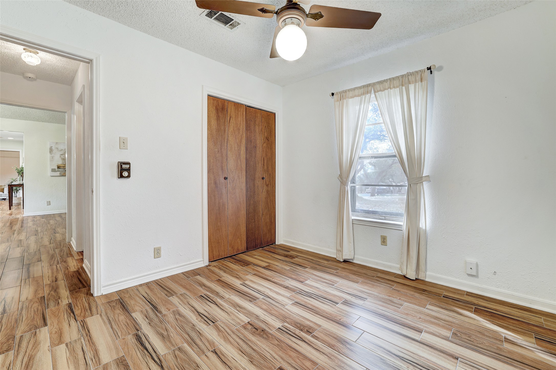 8606 Thunderbird Road, Unit A & B Austin, TX 78736 - Photo 27 of 33 wooden floor in an empty room with a window