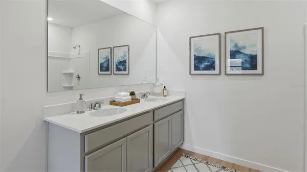 a bathroom with 2 sink and a mirror