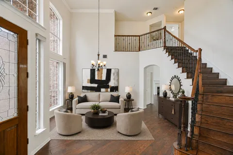 a very nice looking living room with furniture and a potted plant