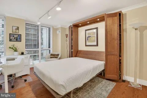 a bedroom with a large bed and a window