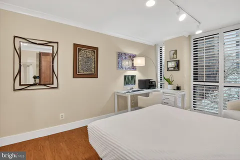 a bedroom with a bed and a view of kitchen