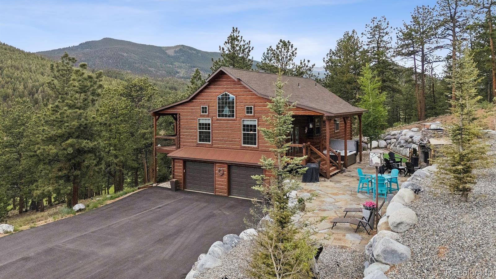 a view of a house with a yard and mountain view