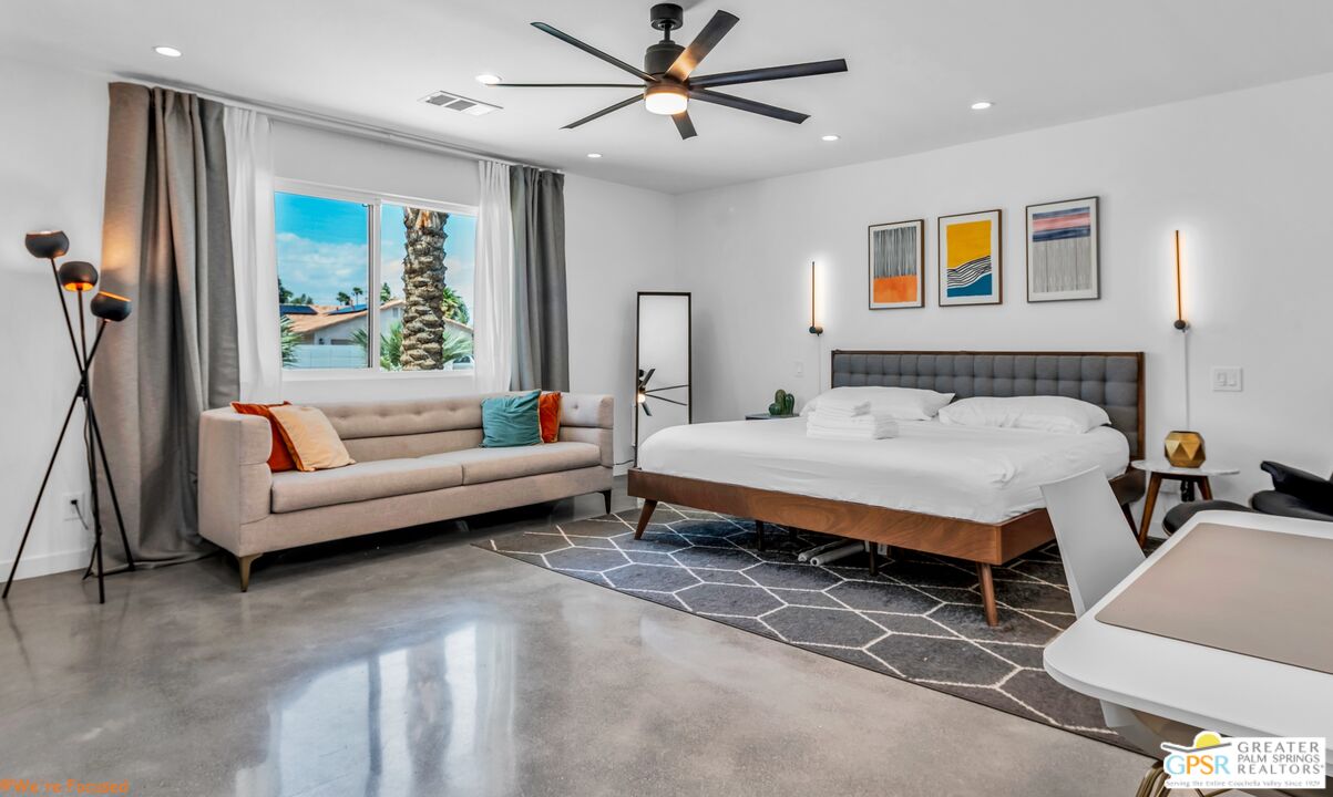 545 West Yorba Road Palm Springs, CA 92262 - Photo 17 of 72 a bedroom with a bed couches and a flat tv screen