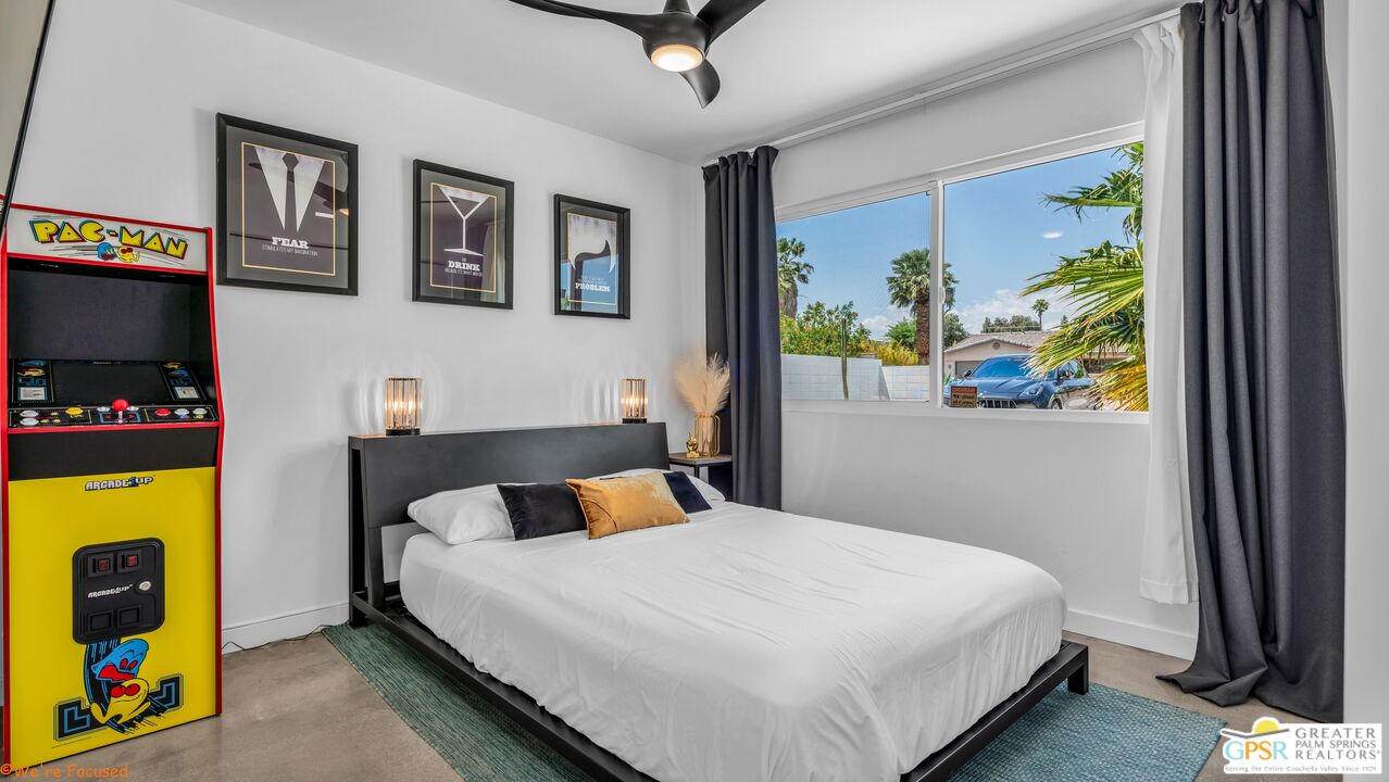 545 West Yorba Road Palm Springs, CA 92262 - Photo 27 of 72 a bedroom with a bed painting on wall and a large window