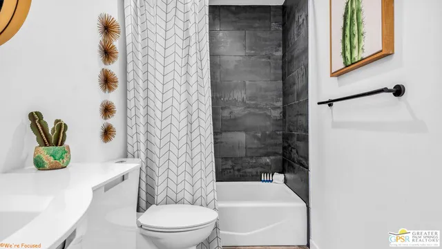 a bathroom with a toilet a sink and a mirror