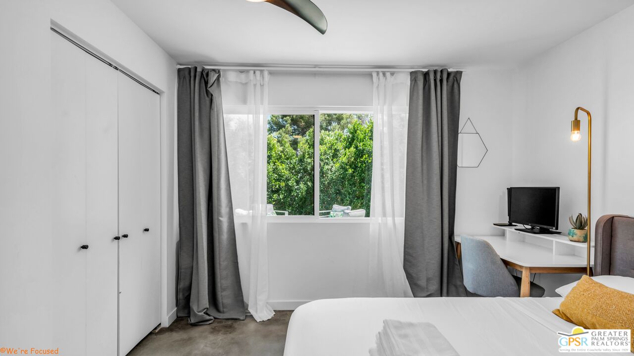 545 West Yorba Road Palm Springs, CA 92262 - Photo 36 of 72 a bedroom with a bed television on desk and a window