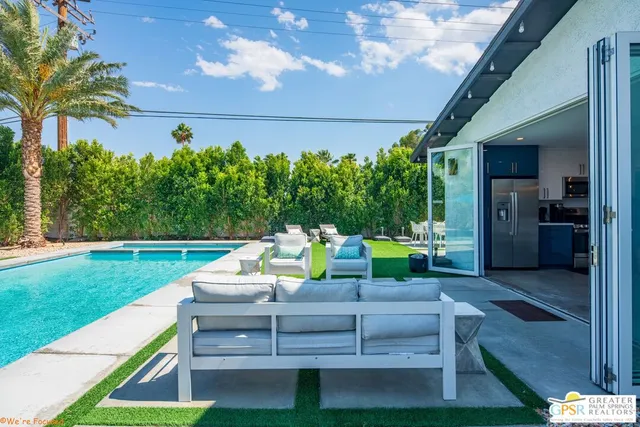 a view of a backyard with sitting area