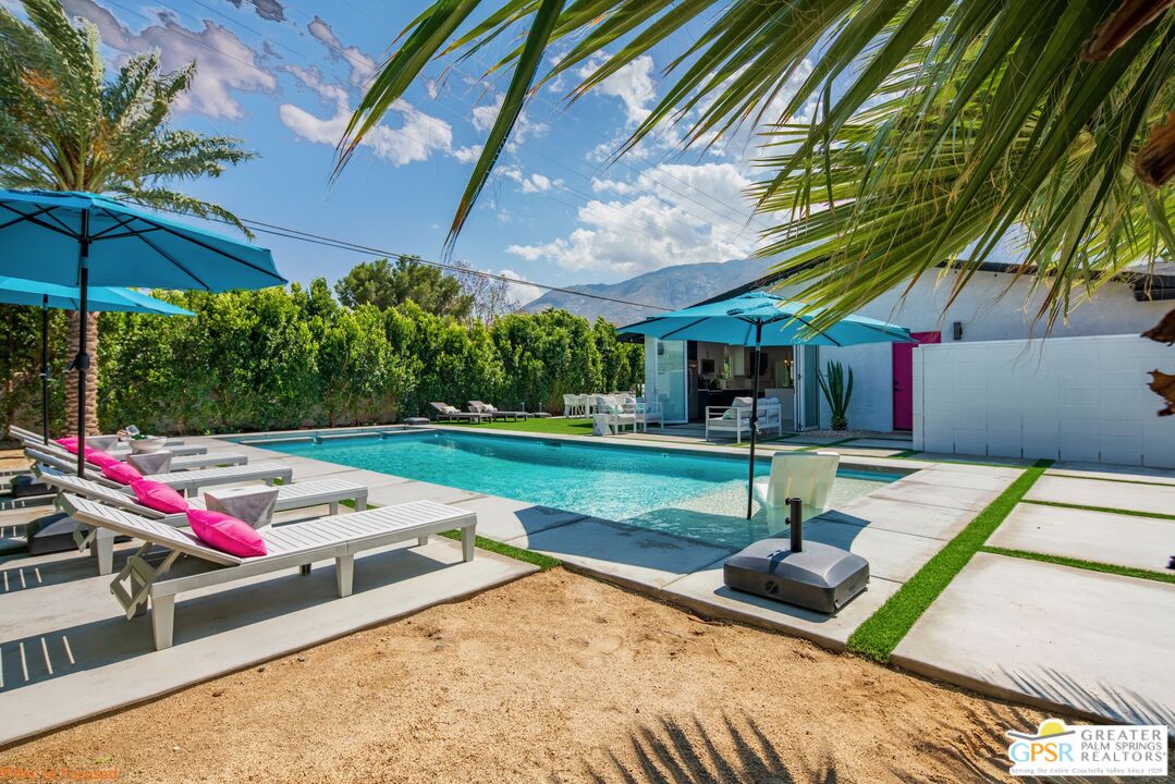 545 West Yorba Road Palm Springs, CA 92262 - Photo 45 of 72 a view of a backyard with table and chairs under an umbrella