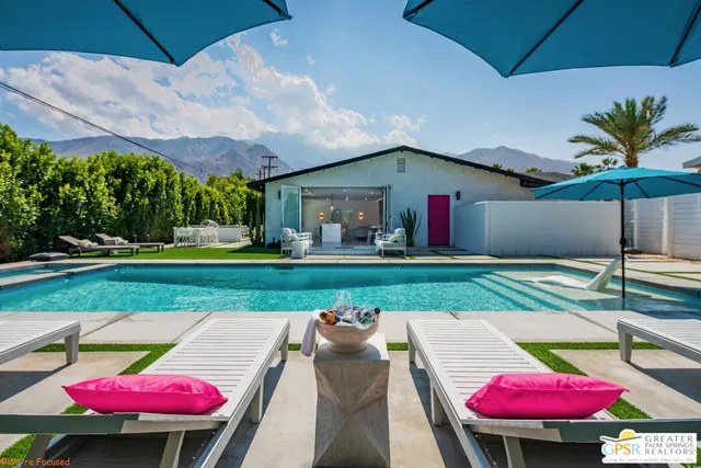 a view of a swimming pool in the backyard of a house