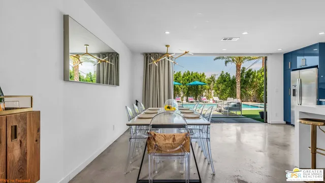 a kitchen with stainless steel appliances granite countertop a stove a refrigerator and a sink