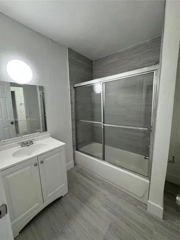 a view of bathroom with a sink and mirror