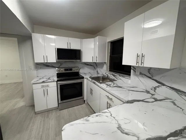 a kitchen with a stove and a microwave