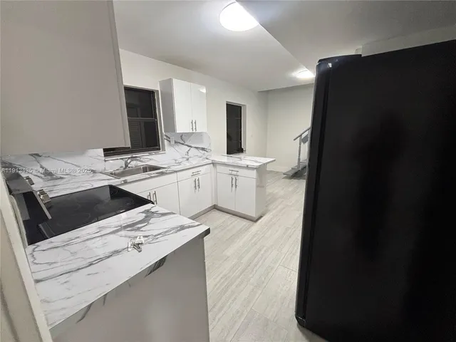a kitchen that has a sink and a stove in it
