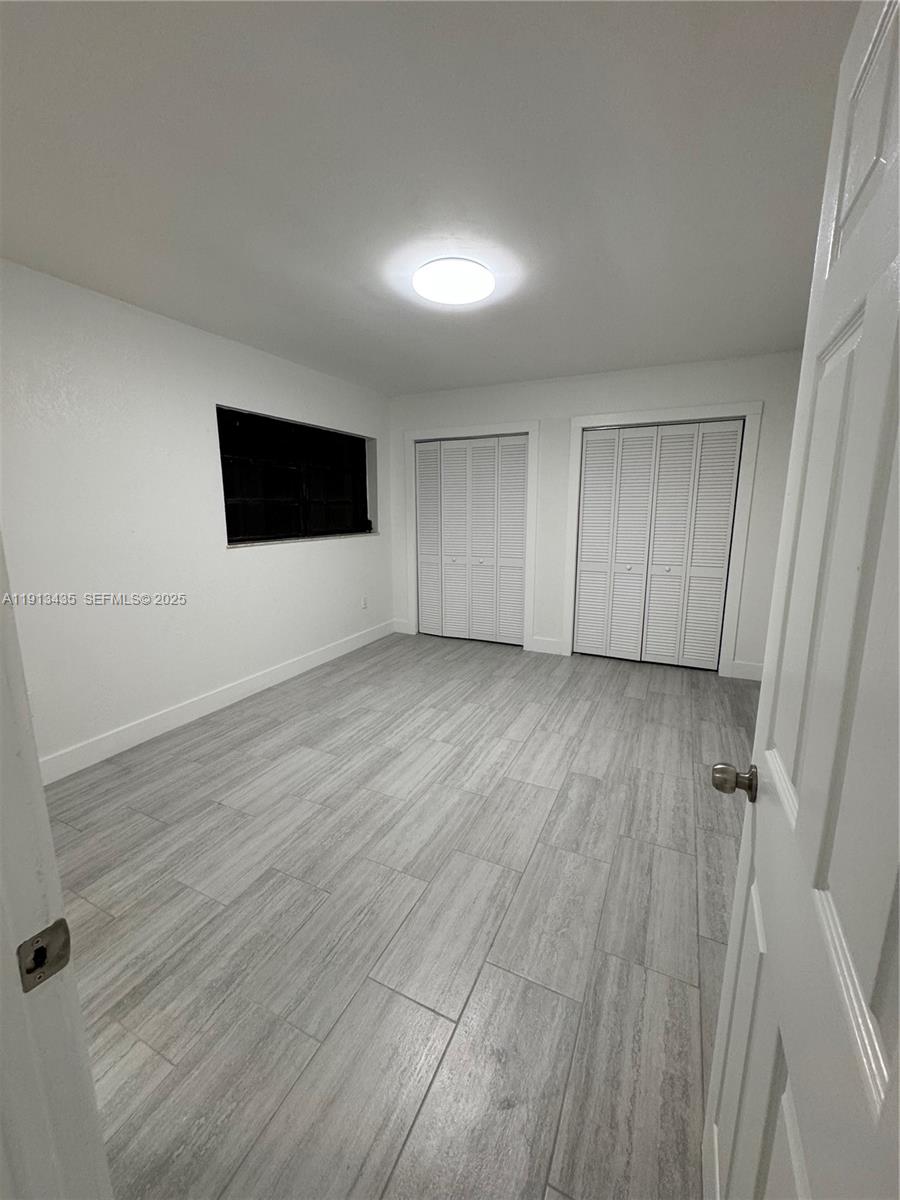 1799 Southwest 36th Avenue, Unit 1 Miami, FL 33145 - Photo 8 of 14 a view of a livingroom with wooden floor