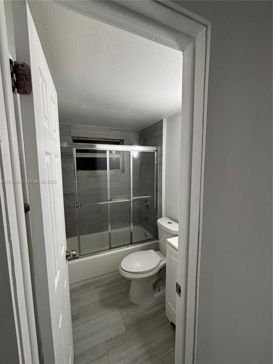 1799 Southwest 36th Avenue, Unit 1 Miami, FL 33145 - Photo 9 of 14 a bathroom with a toilet and a shower
