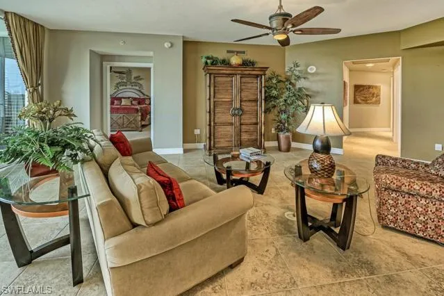 a living room with furniture and a potted plant