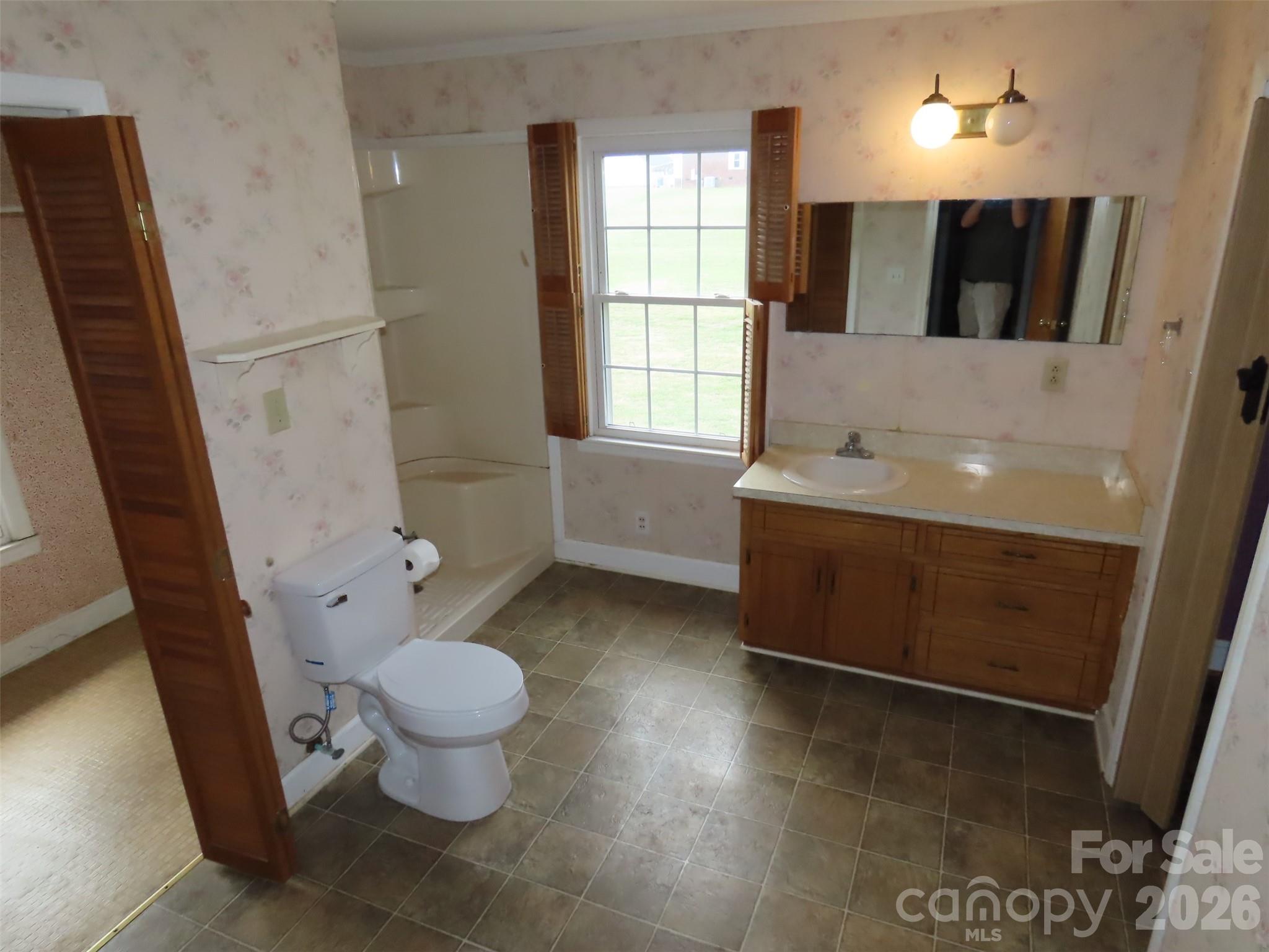 2724 Lucy Short Cut Road Marshville, NC 28103 - Photo 19 of 28 a bathroom with a sink a toilet and a large mirror