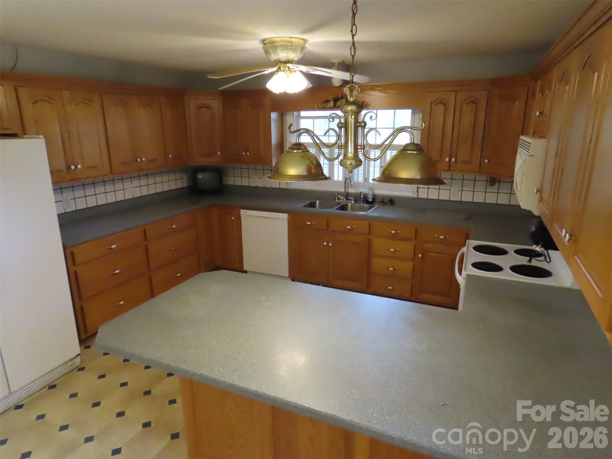 2724 Lucy Short Cut Road Marshville, NC 28103 - Photo 10 of 28 a kitchen with stainless steel appliances granite countertop a sink a stove and a refrigerator
