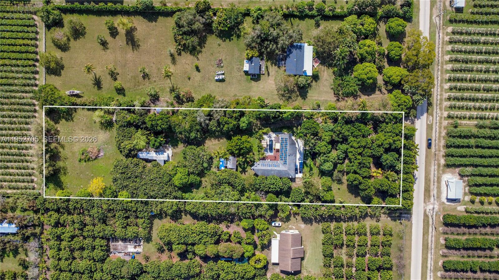 37225 Southwest 214th Avenue Homestead, FL 33034 - Photo 2 of 77 an aerial view of a residential houses with outdoor space
