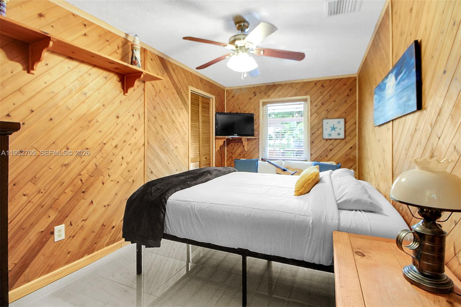 37225 Southwest 214th Avenue Homestead, FL 33034 - Photo 62 of 77 a bedroom with a bed and a chandelier