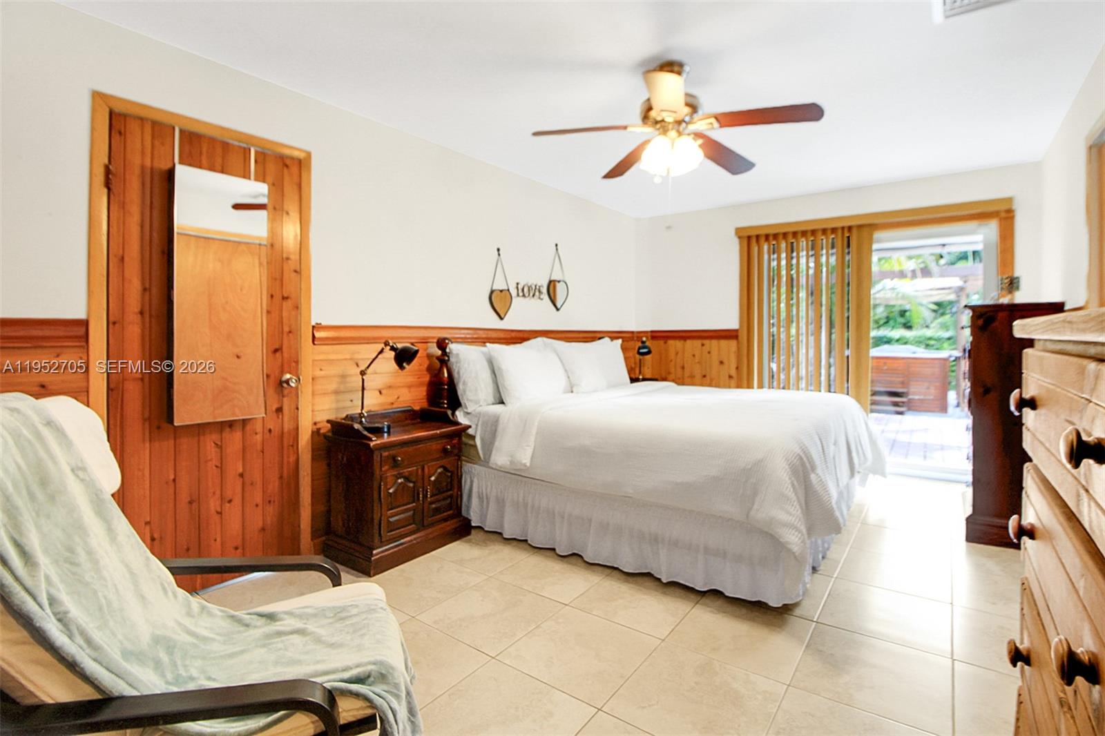 37225 Southwest 214th Avenue Homestead, FL 33034 - Photo 64 of 77 a bedroom with a bed and wooden floor