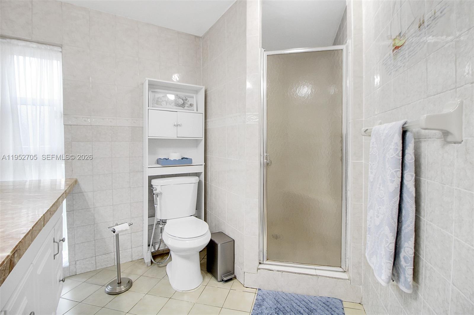 37225 Southwest 214th Avenue Homestead, FL 33034 - Photo 68 of 77 a bathroom with a granite countertop toilet a sink and a mirror