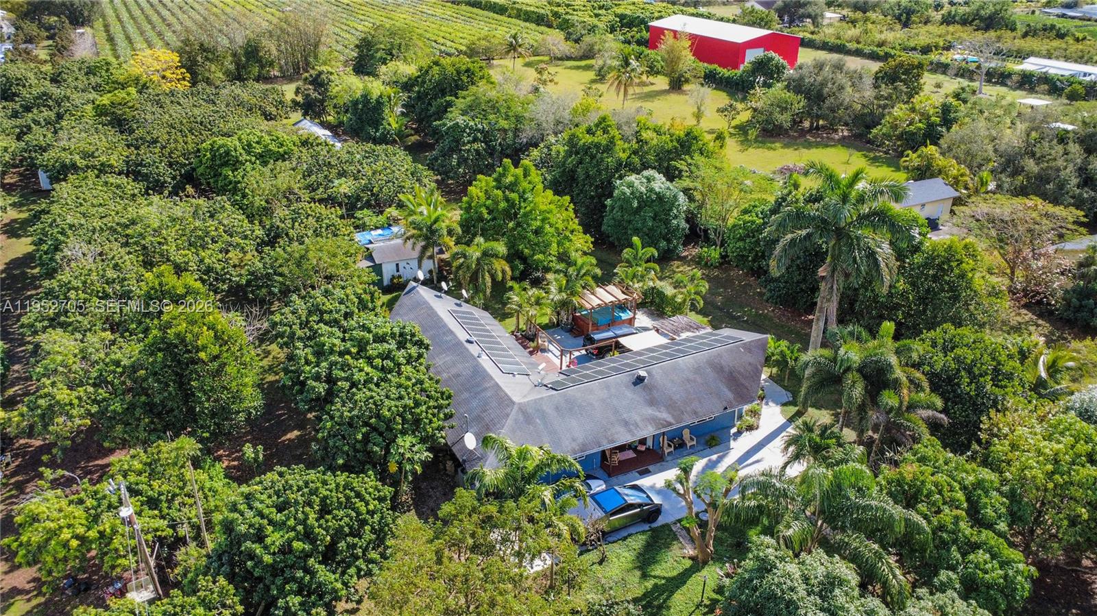 37225 Southwest 214th Avenue Homestead, FL 33034 - Photo 70 of 77 an aerial view of a house with a yard and covered with swimming pool