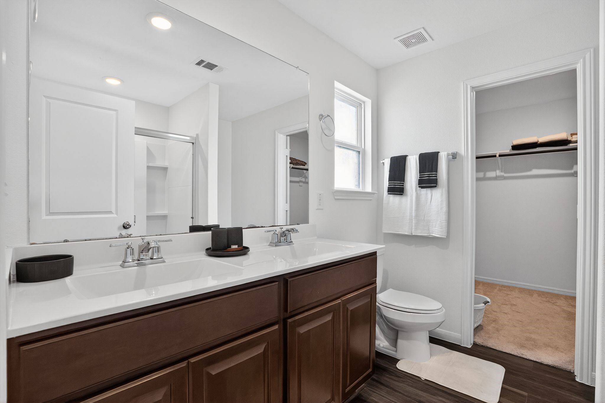 17866 Juneberry Seed Street Hockley, TX 77447 - Photo 13 of 26 a bathroom with a granite countertop sink toilet a mirror and shower