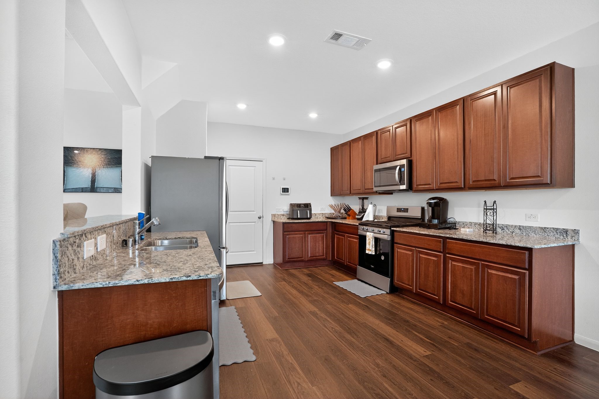 17866 Juneberry Seed Street Hockley, TX 77447 - Photo 8 of 26 a kitchen with stainless steel appliances granite countertop a sink refrigerator and cabinets