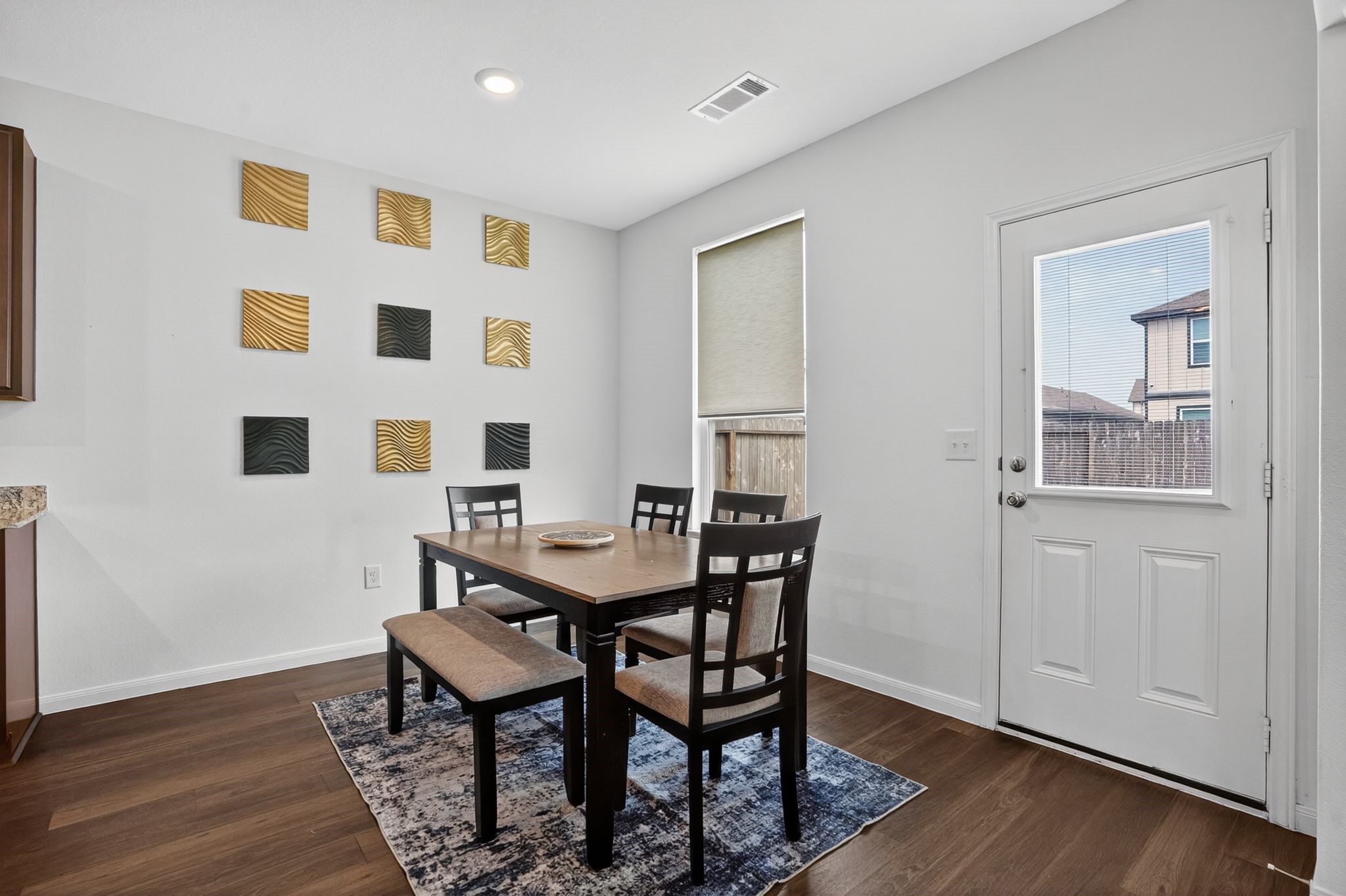 17866 Juneberry Seed Street Hockley, TX 77447 - Photo 9 of 26 a view of a dining room with furniture and wooden floor