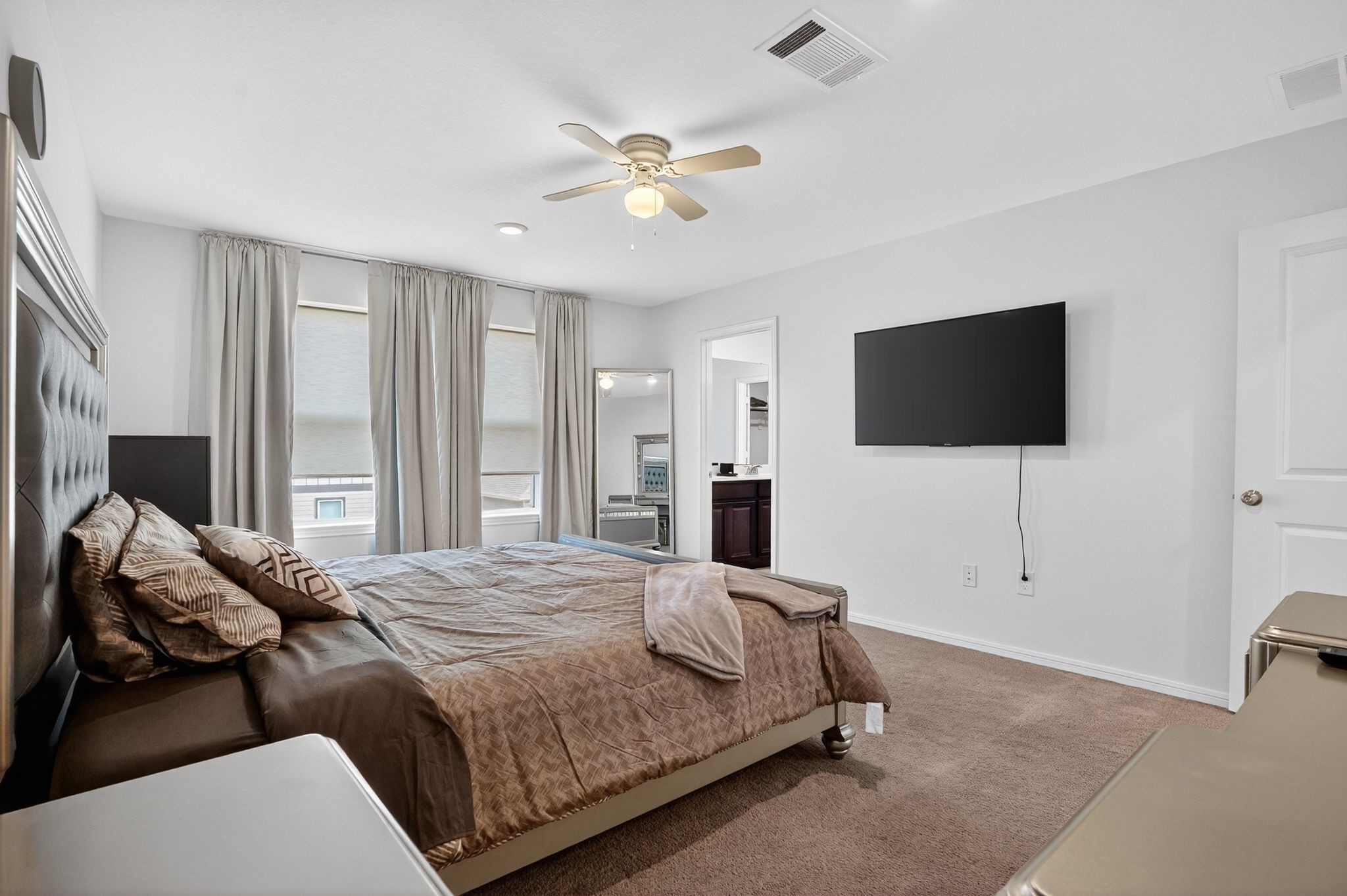 17866 Juneberry Seed Street Hockley, TX 77447 - Photo 10 of 26 a bedroom with a bed tv and a window