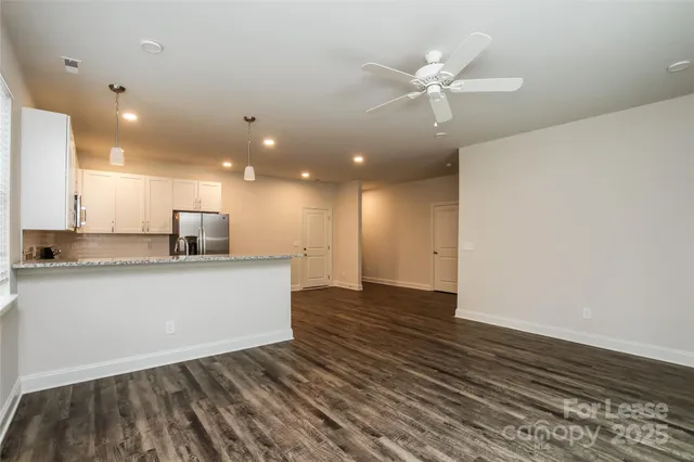 a view of kitchen with granite countertop cabinets and wooden floor