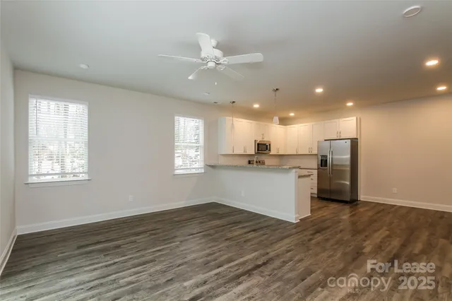 a view of kitchen with wooden floor and window