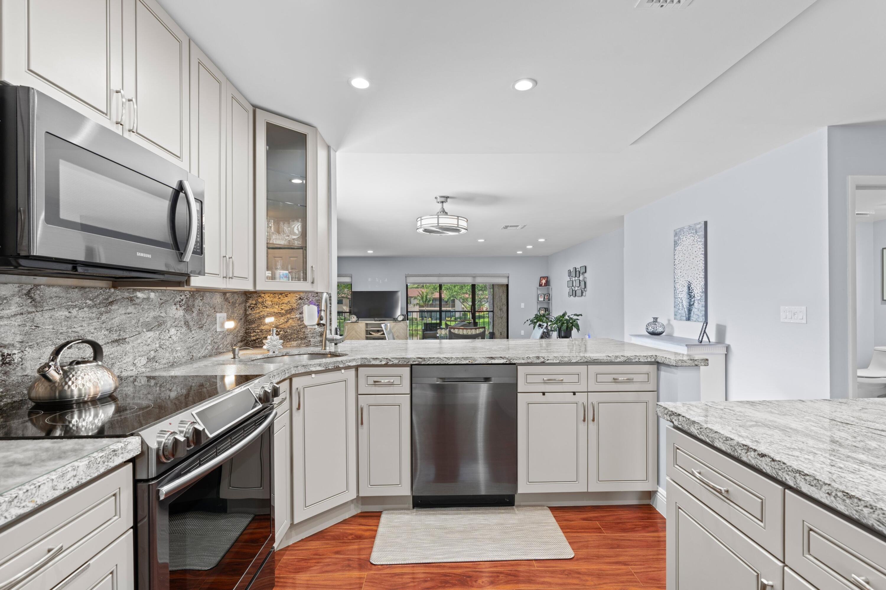 9265 Vista Del Lago, Unit 41B Boca Raton, FL 33428 - Photo 11 of 42 a kitchen with a sink stove and cabinets