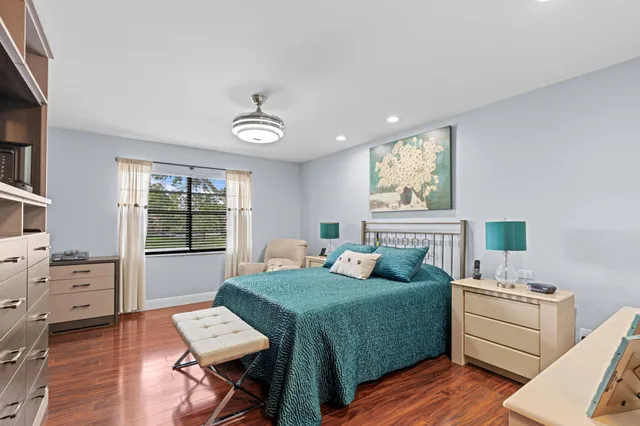 a bedroom with a bed window and table