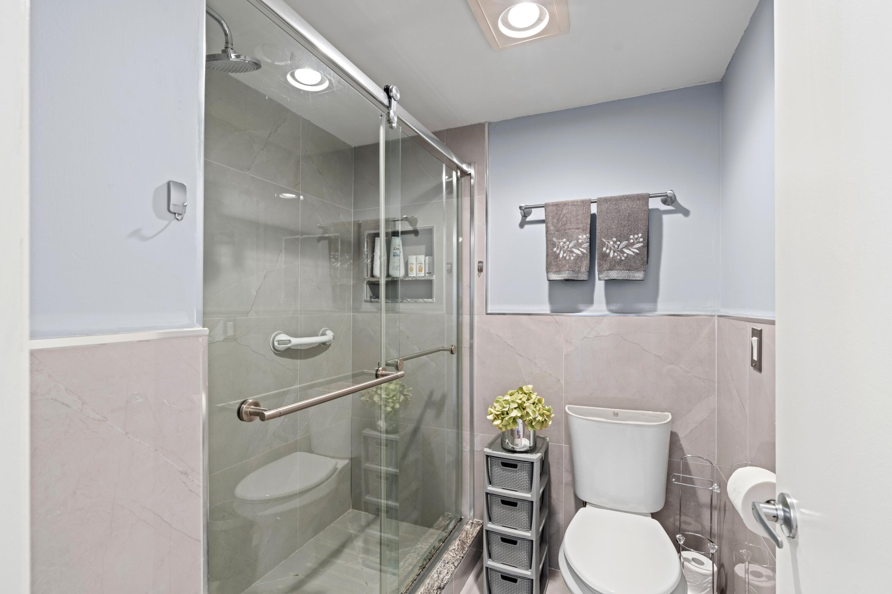 9265 Vista Del Lago, Unit 41B Boca Raton, FL 33428 - Photo 17 of 42 a bathroom with a toilet and a shower