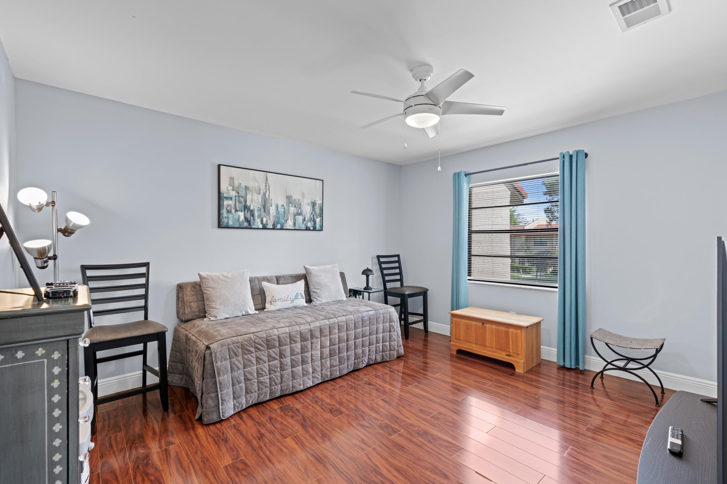 9265 Vista Del Lago, Unit 41B Boca Raton, FL 33428 - Photo 18 of 42 a living room with furniture and a wooden floor