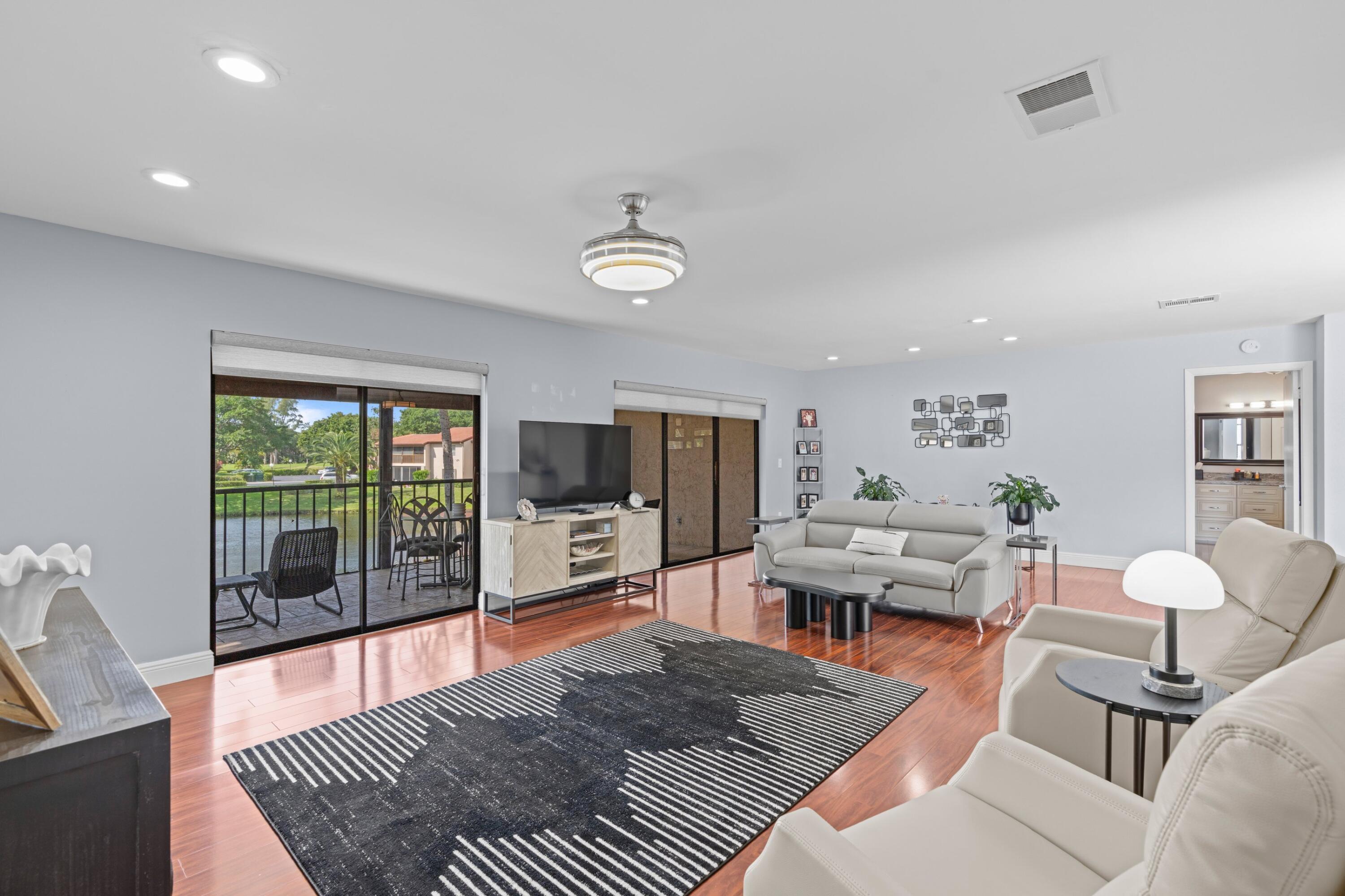 9265 Vista Del Lago, Unit 41B Boca Raton, FL 33428 - Photo 6 of 42 a living room with furniture and a flat screen tv