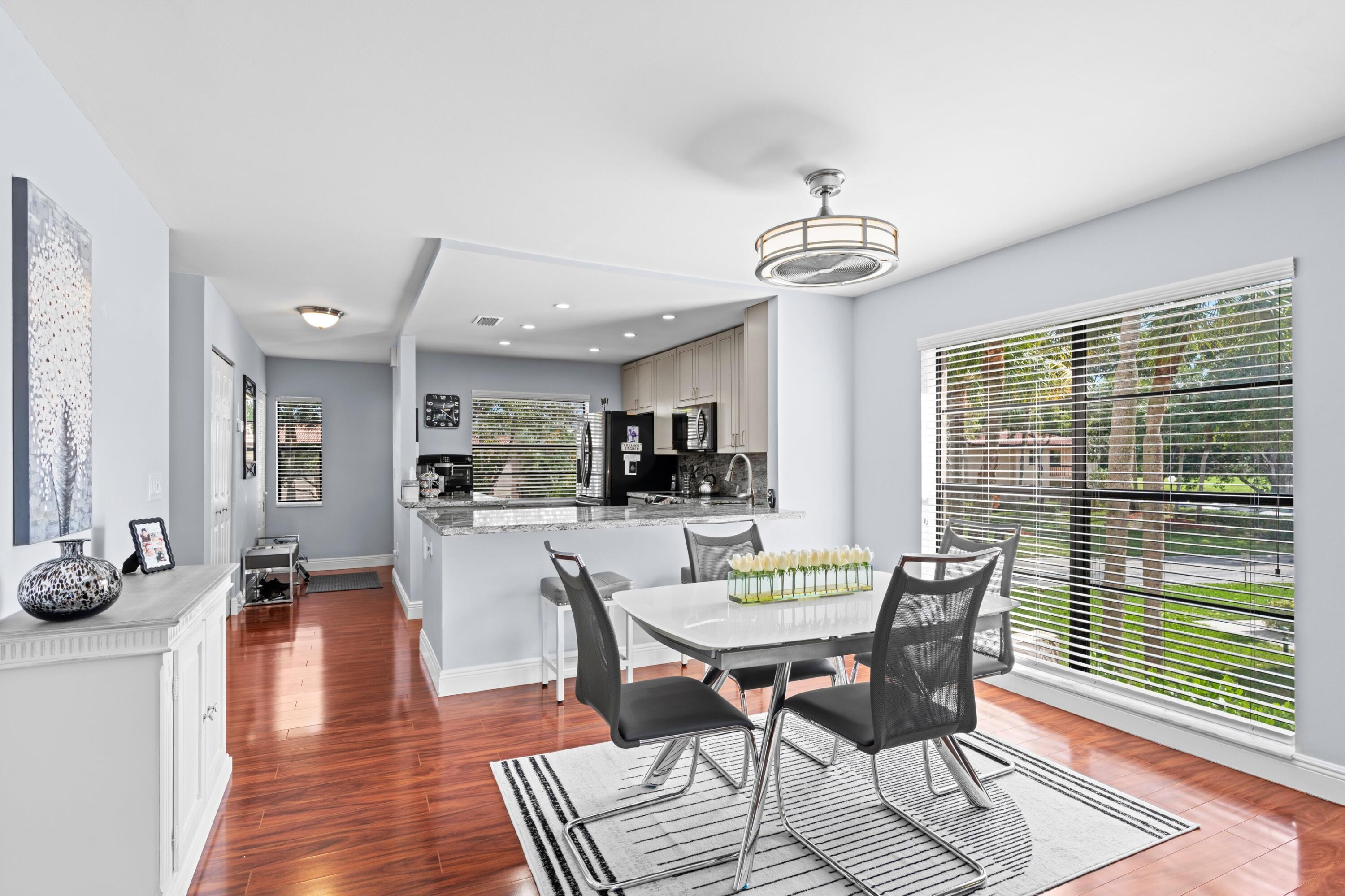 9265 Vista Del Lago, Unit 41B Boca Raton, FL 33428 - Photo 7 of 42 a view of a dining room with furniture window and wooden floor