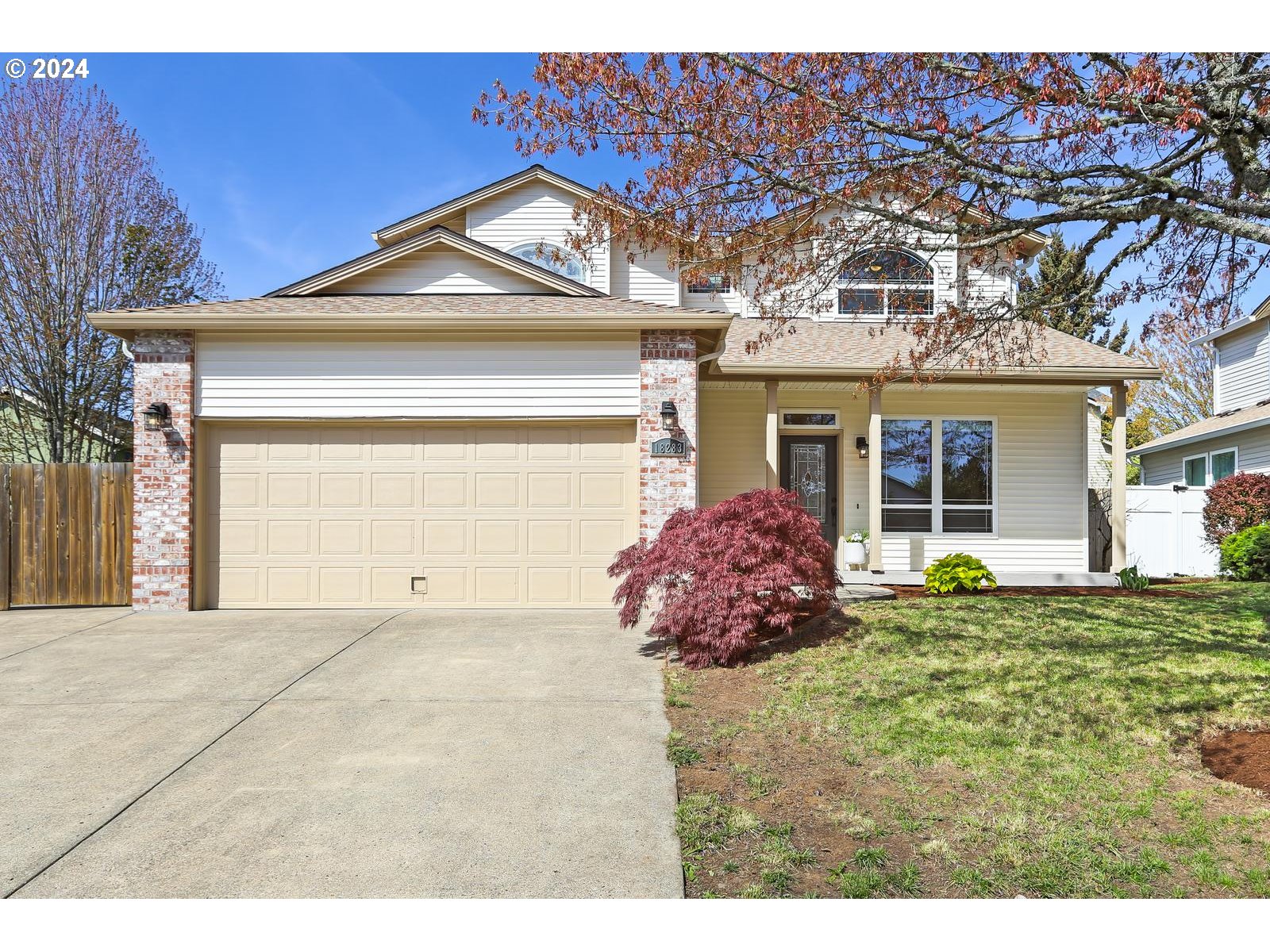 18283 Davis Street Sandy, OR 97055 - Photo 1 of 42 a front view of a house with a garden and plants