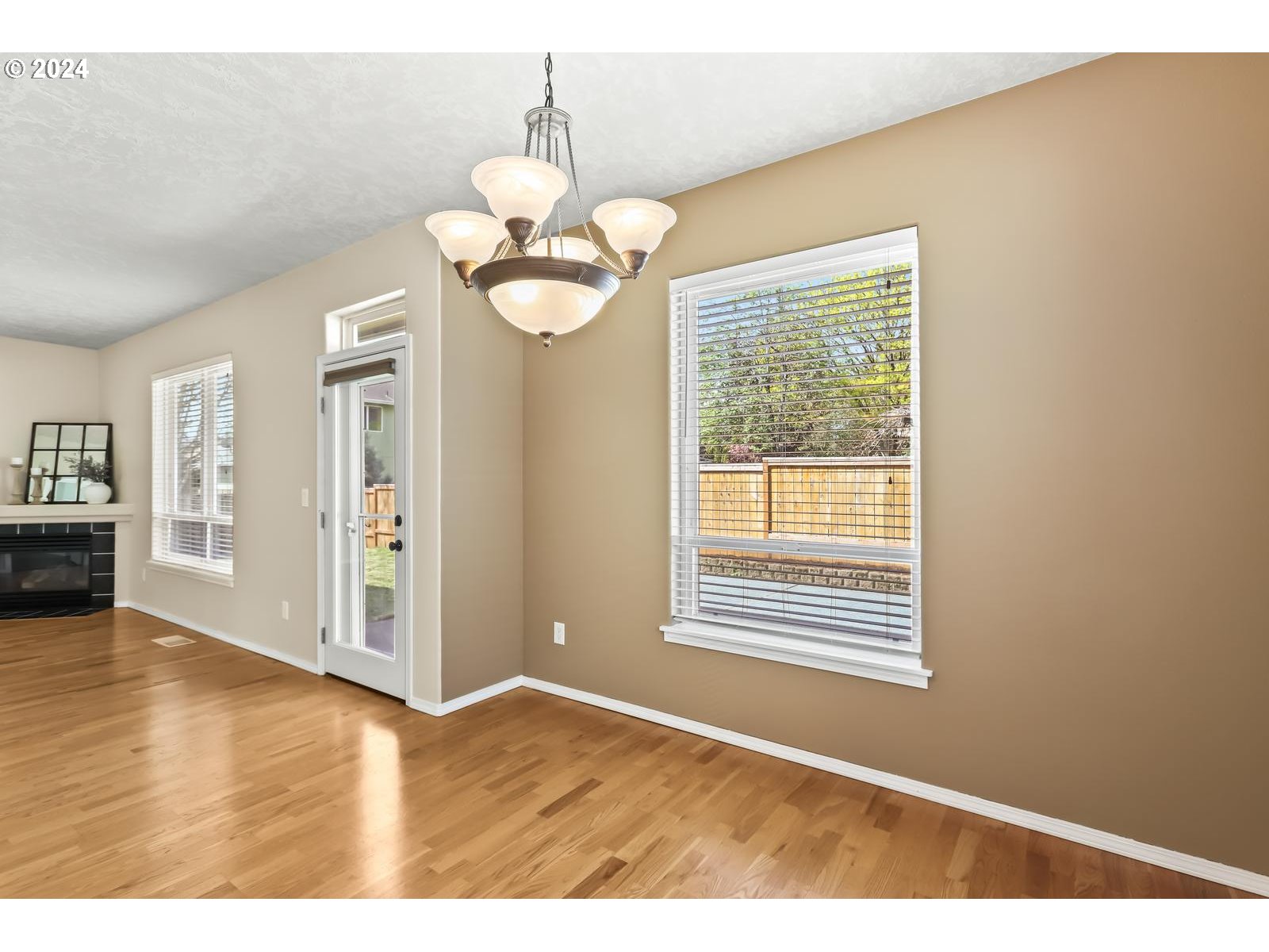 18283 Davis Street Sandy, OR 97055 - Photo 13 of 42 a view of an empty room with window and wooden floor
