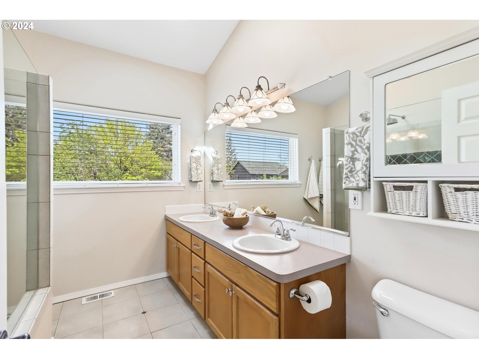 18283 Davis Street Sandy, OR 97055 - Photo 25 of 42 a bathroom with a sink a mirror and a toilet