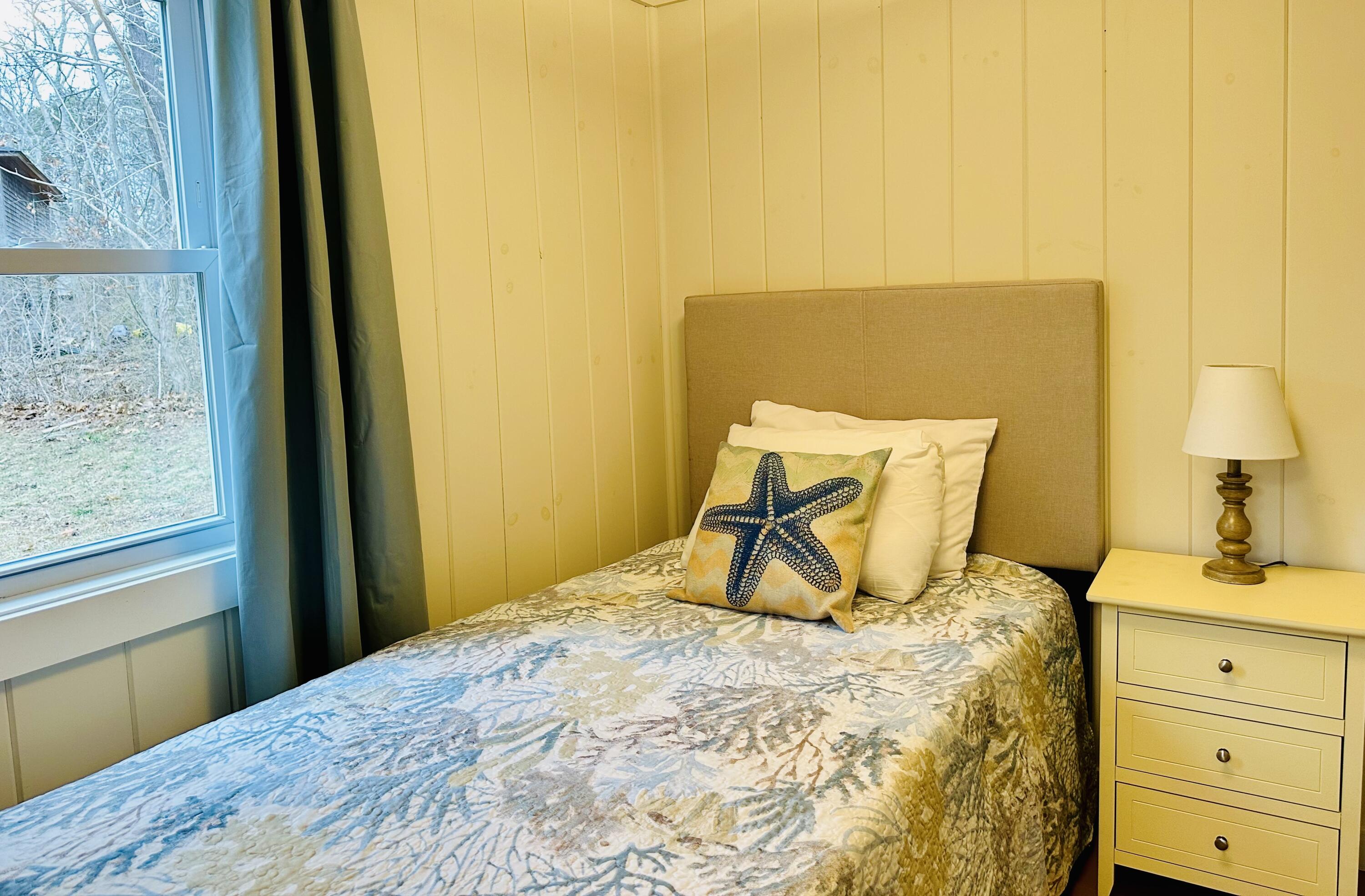 36 Cove Road Wellfleet, MA 02667 - Photo 17 of 22 a bedroom with a bed and wooden floor