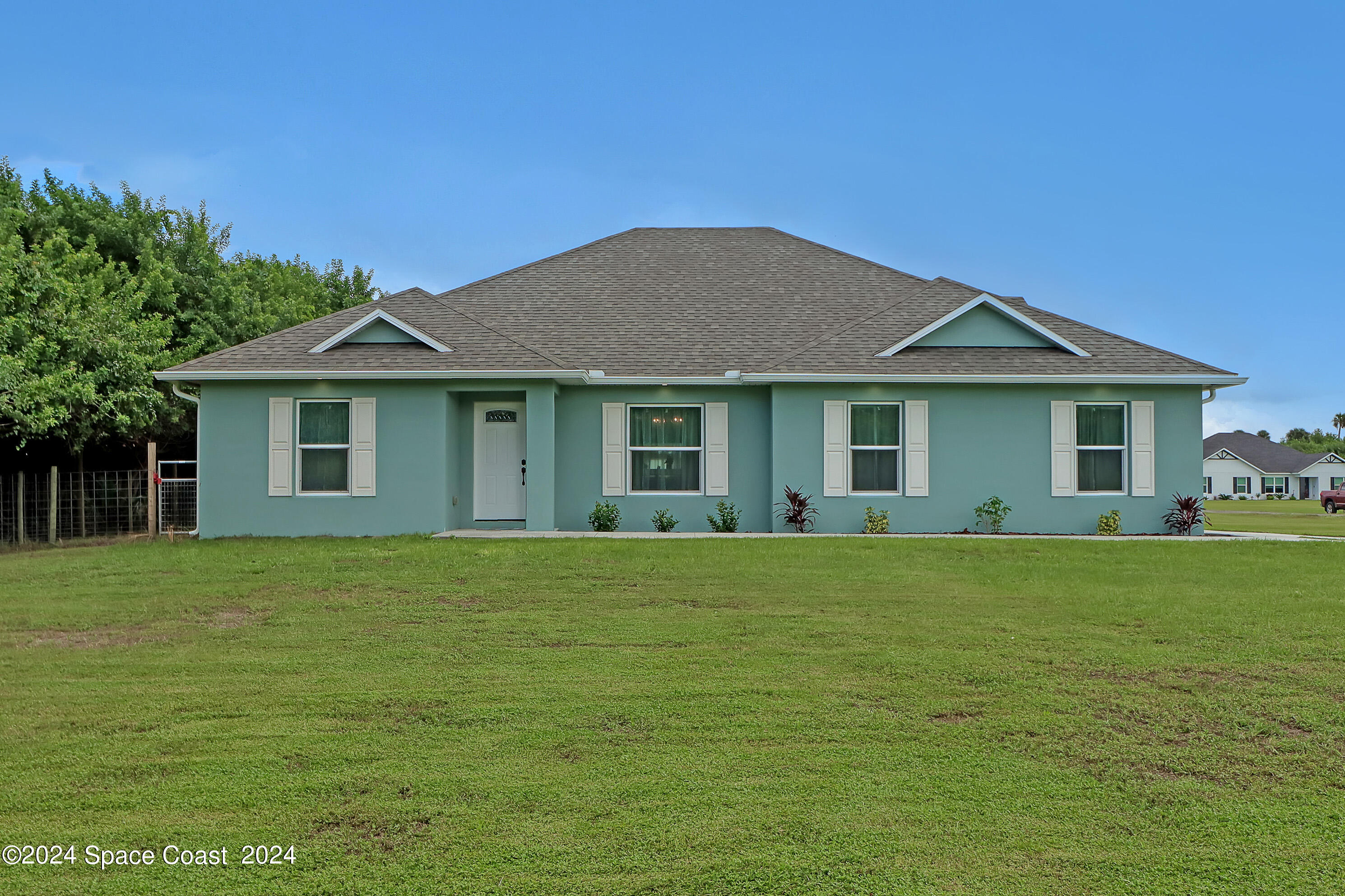 4383 Prentice Lane Mims, FL 32754 - Photo 1 of 48 a front view of a house with a garden