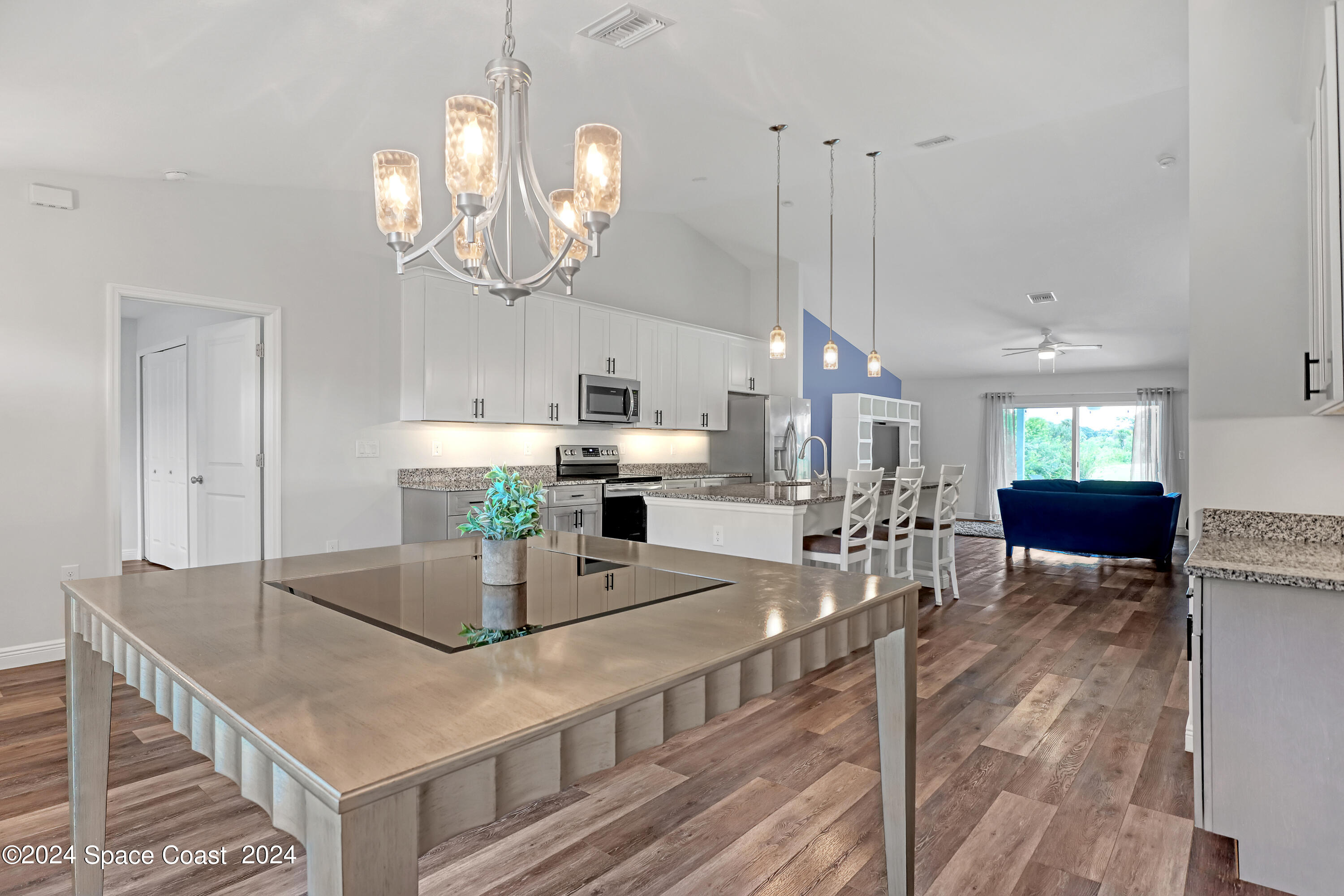 4383 Prentice Lane Mims, FL 32754 - Photo 14 of 48 a kitchen with kitchen island granite countertop a table chairs sink and cabinets