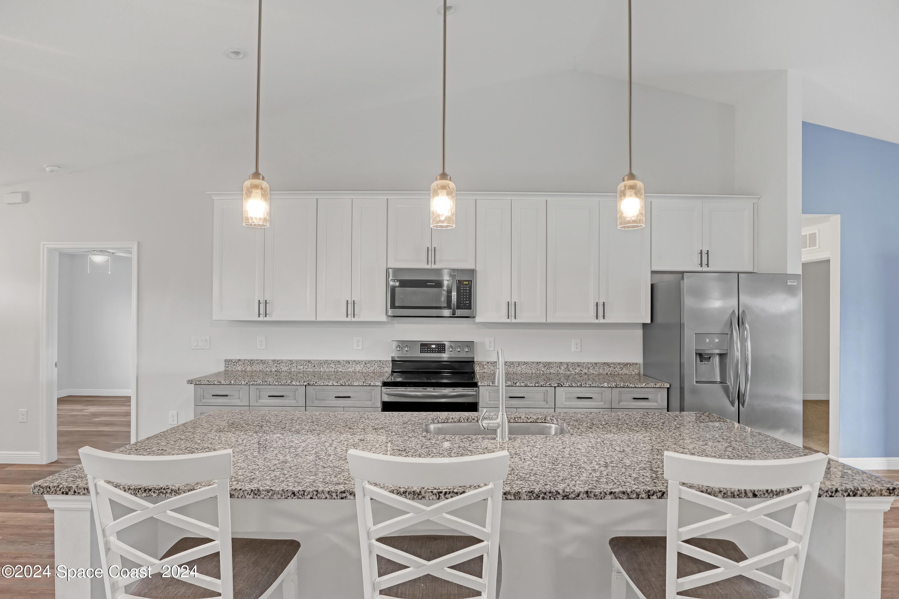 4383 Prentice Lane Mims, FL 32754 - Photo 15 of 48 a kitchen with stainless steel appliances granite countertop a refrigerator a sink a stove a microwave and white cabinets