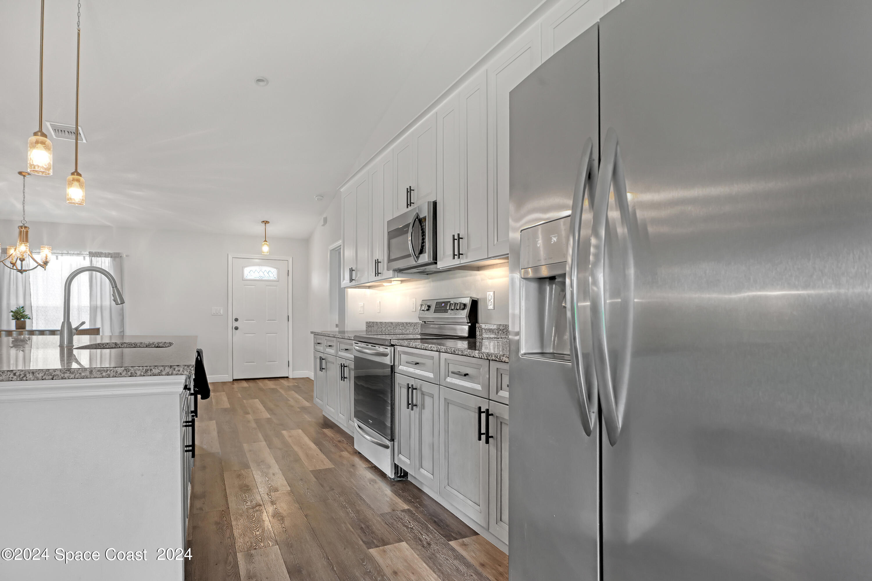 4383 Prentice Lane Mims, FL 32754 - Photo 18 of 48 a kitchen with stainless steel appliances granite countertop a sink stove and refrigerator