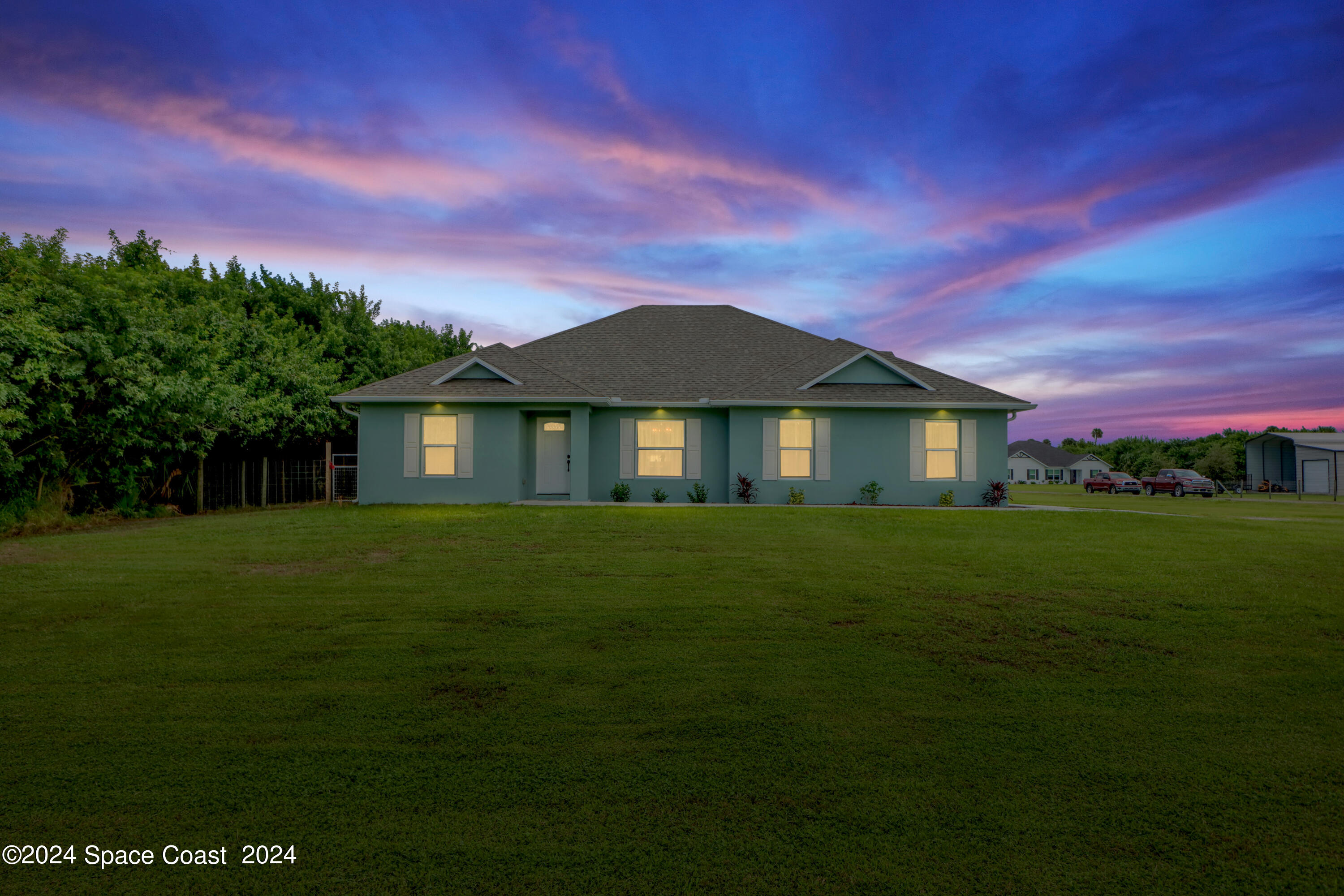 4383 Prentice Lane Mims, FL 32754 - Photo 2 of 48 a front view of a house with a garden