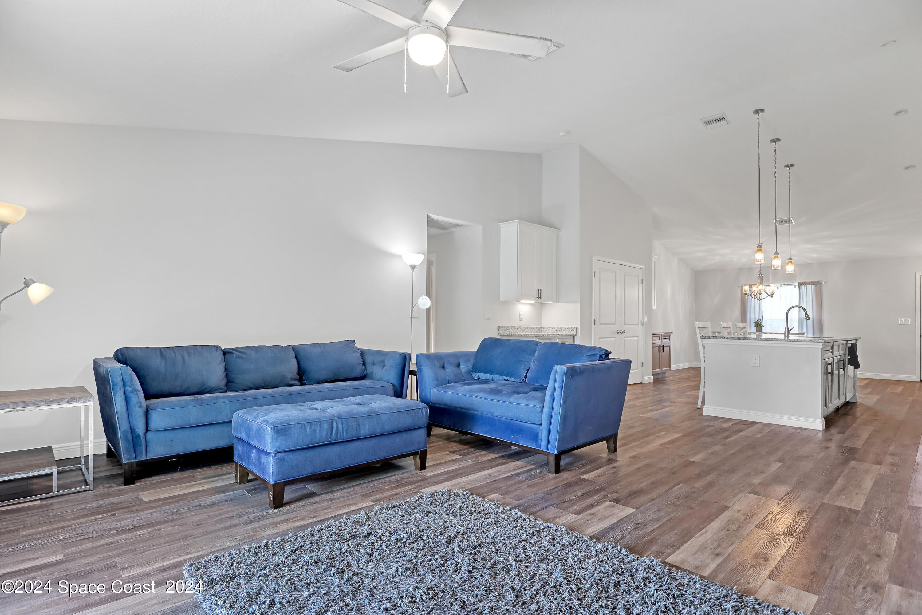4383 Prentice Lane Mims, FL 32754 - Photo 23 of 48 a living room with furniture and a chandelier