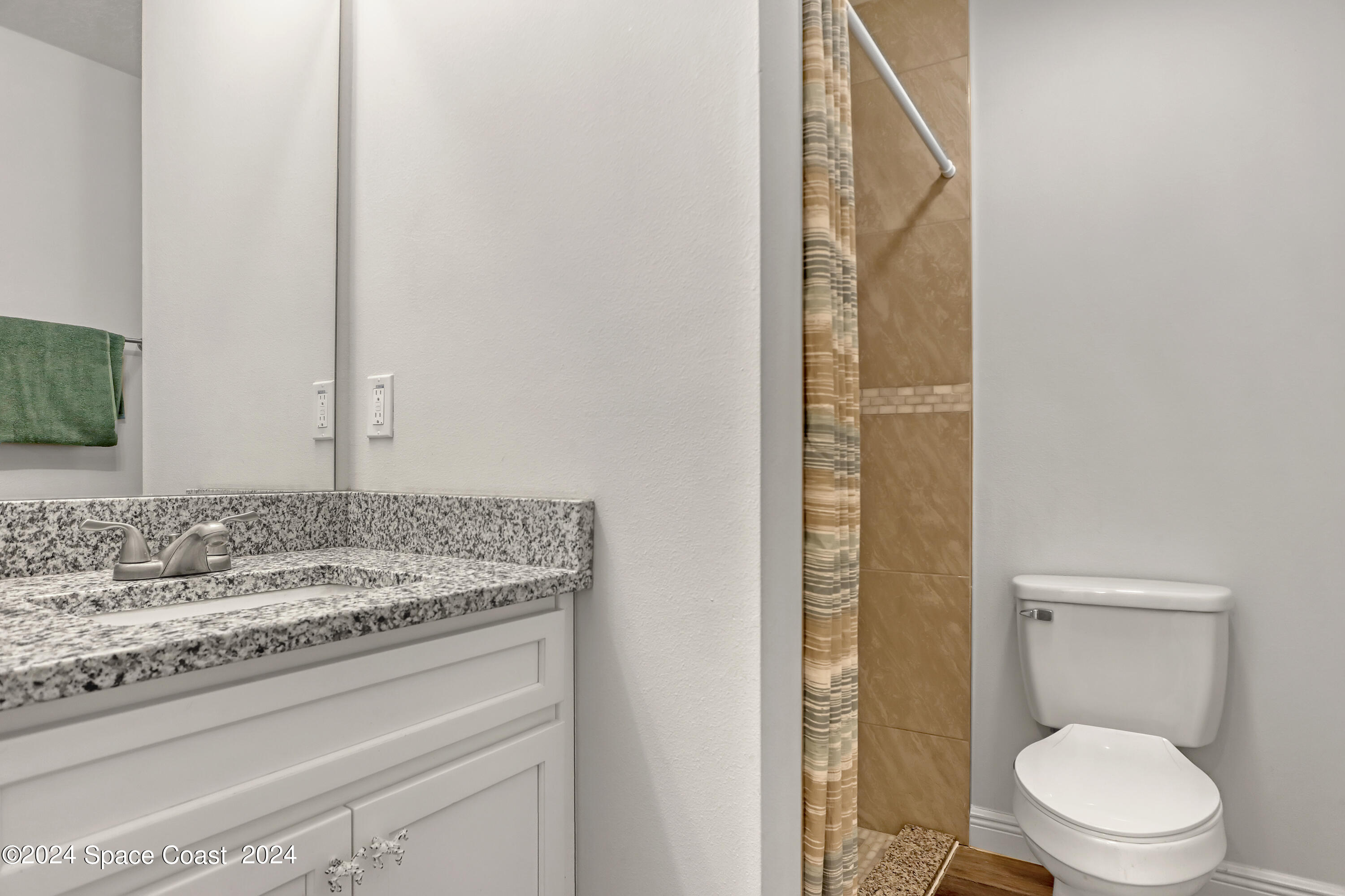 4383 Prentice Lane Mims, FL 32754 - Photo 31 of 48 a bathroom with a granite countertop sink a toilet and shower